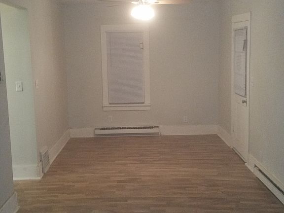 Living area; front door is to the right, hallway is to the left