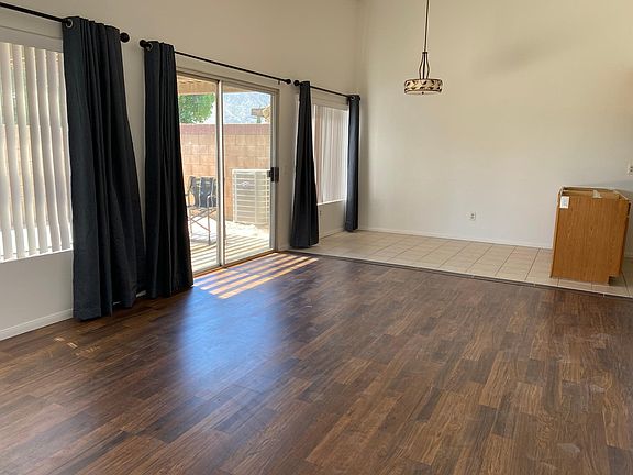 Looking from front door toward dining room. Windows have both vertical blinds and drapes. Drapes have magnets inserted in seams where they meet in the center. When they close it darkens the room to improve TV viewing.