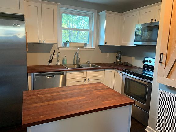 Renovated Kitchen with butcher block countertop and stainless steel appliances