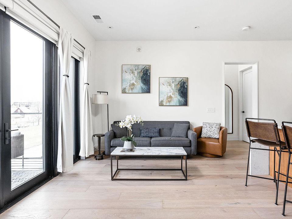 Living space filled with light from wall to wall balcony doors.