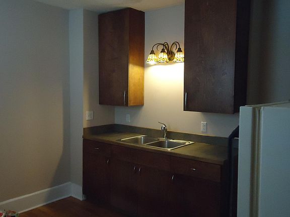 Custom mohogany kitchen cabinets and furnished appliances on wonderful "hardwood" floor....in the kitchen! Awesome!