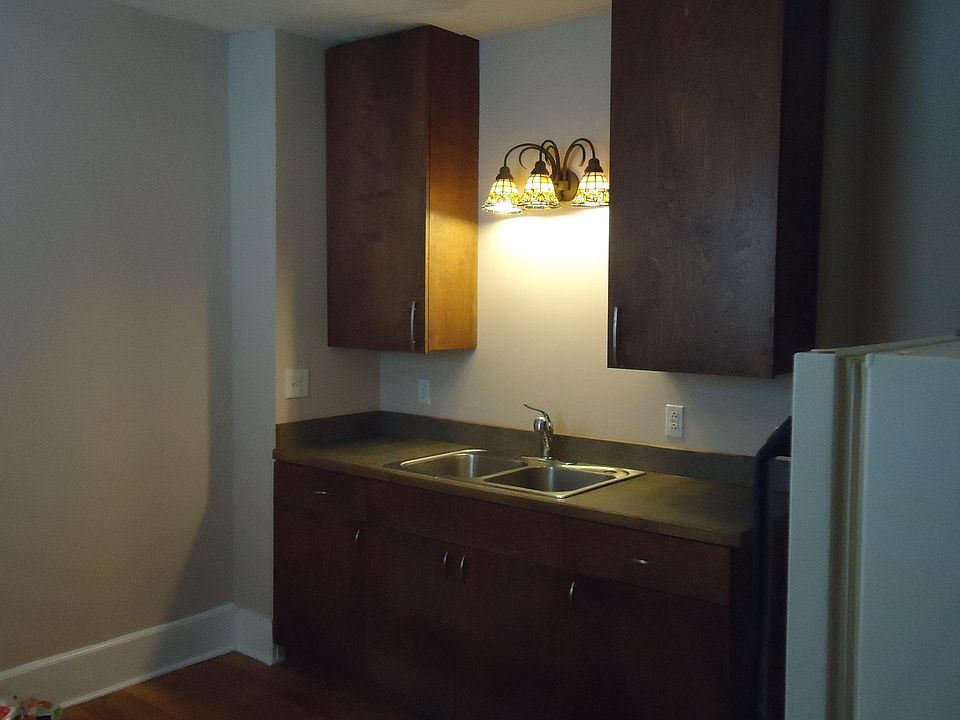Custom mohogany kitchen cabinets and furnished appliances on wonderful "hardwood" floor....in the kitchen! Awesome!