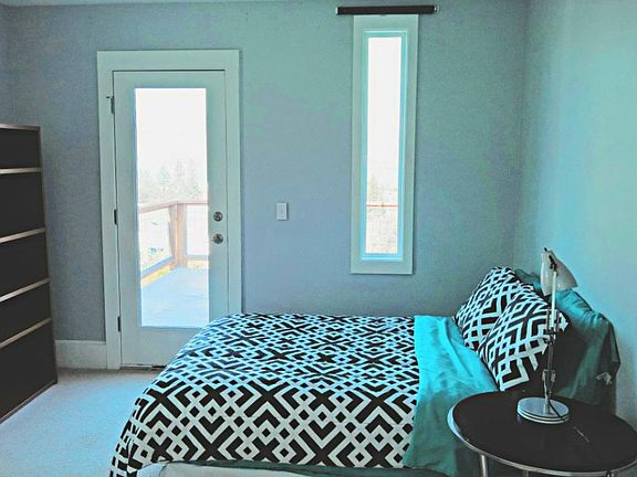 Bedroom #3 with full bed, door to deck and views