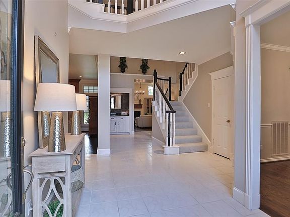 SOARING ENTRY: Open the front doors to a two story entry hall, highlighted by a handsome staircase.