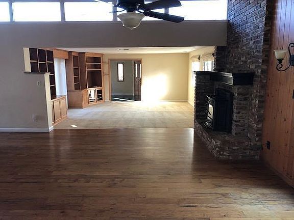 Living room and entry room taken from the dining area. Pellet stove insert in fireplace in dining area.