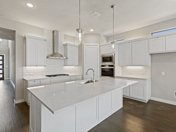 Kitchen in the Rainier home plan by Trophy Signature Homes - REPRESENTATIVE PHOTO