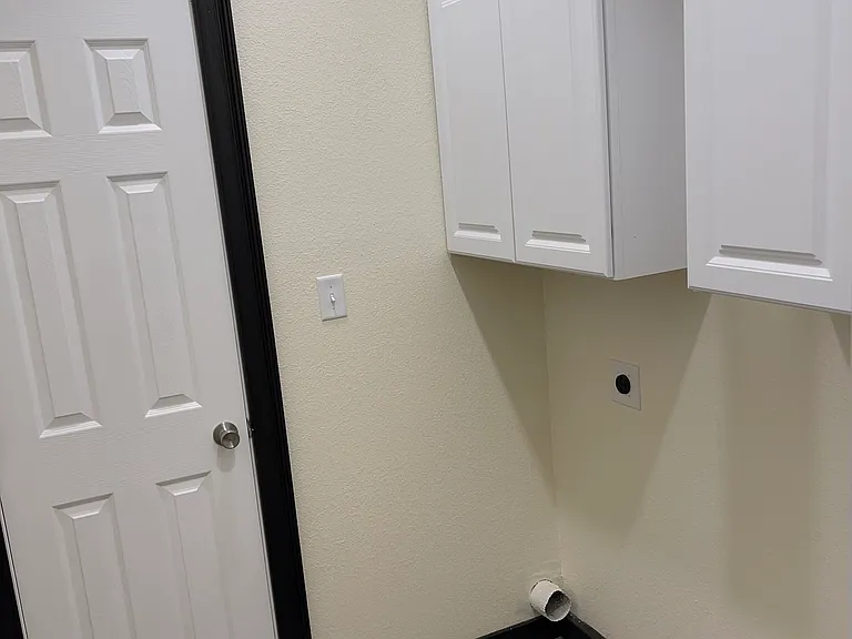 Laundry room with closet