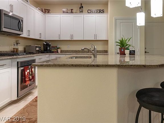 Huge island facing the white cabinets.