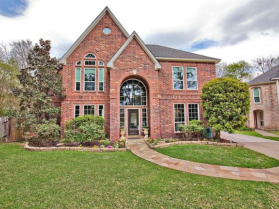 A stone pathway lead you to the front door where you will find a beautiful tiled step-up. The landscape is boldly outlined with large Texas stone and pops with colorful flowers and fresh mulch.