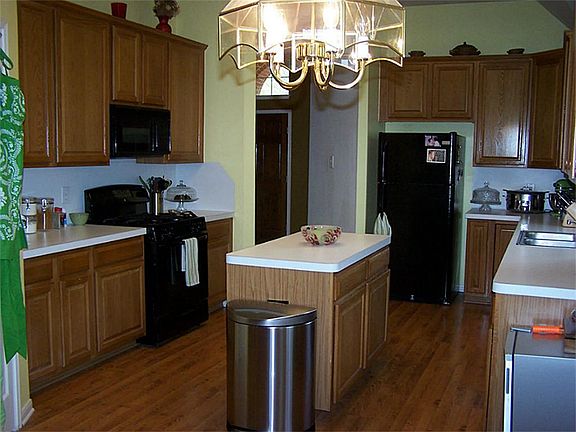 Large eat-in-kitchen with an island, new stove, and new refrigerator, and lots of cabinet space.