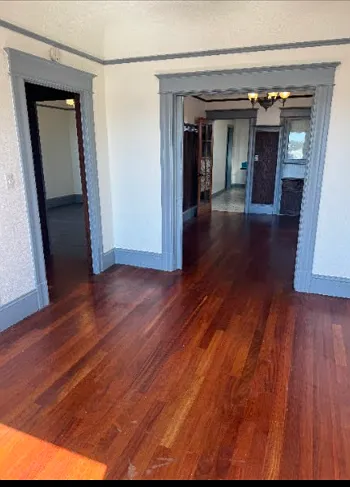 living room - photo taken from front windows looking into dining room 
(entryway is left door)