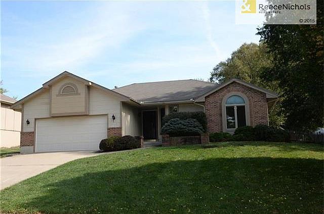 Front view with a 2 car garage, nice front lawn and mature trees. Close to schools and Lake Jacomo.