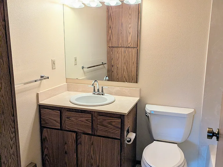 Full bath with linen closet on left (pictured in mirror)
