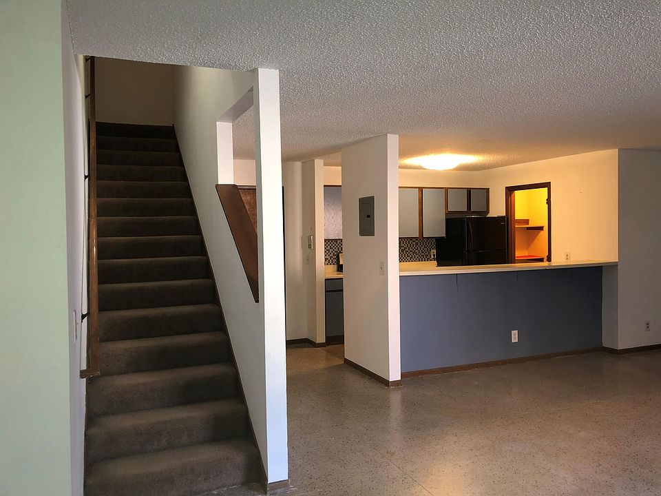 Living room looking into kitchen and upstairs.