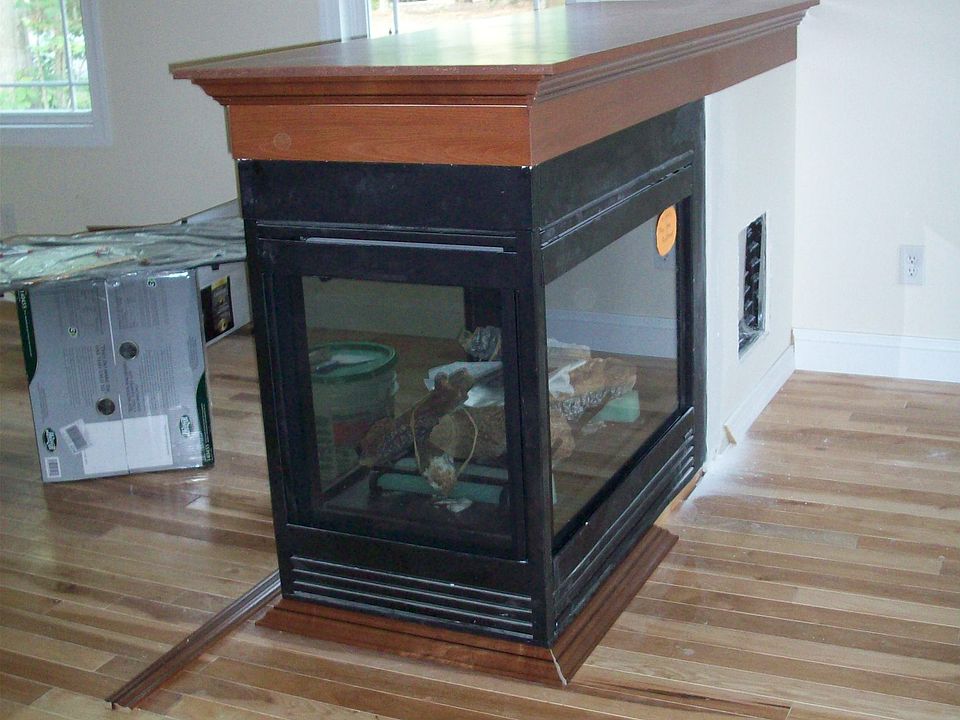 3 SIDED PIER FIREPLACE WITH VIEWS FROM LIVINGROOM AND DINING ROOM