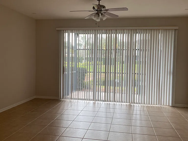 living room with view of lanai and pond