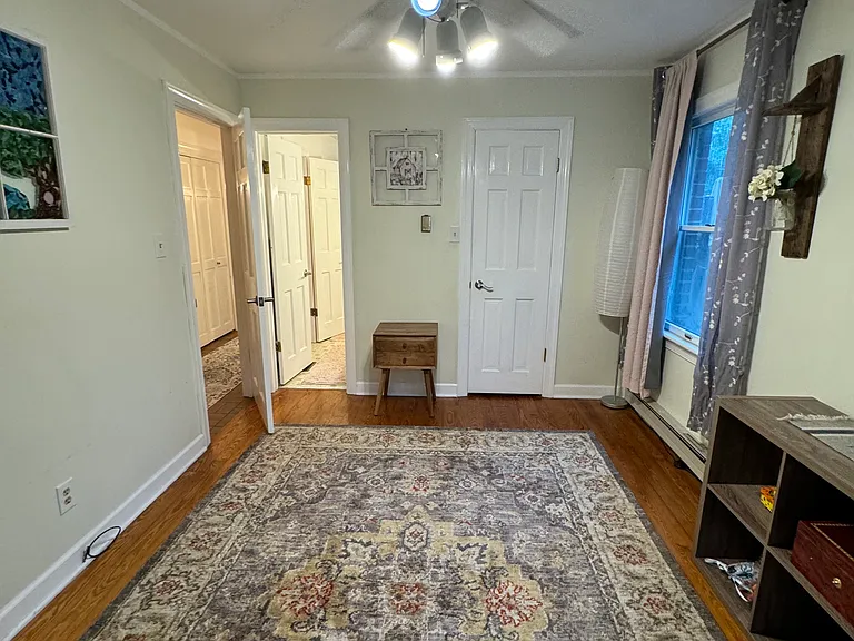 Downstairs Left bedroom with shared bathroom with shower and tub