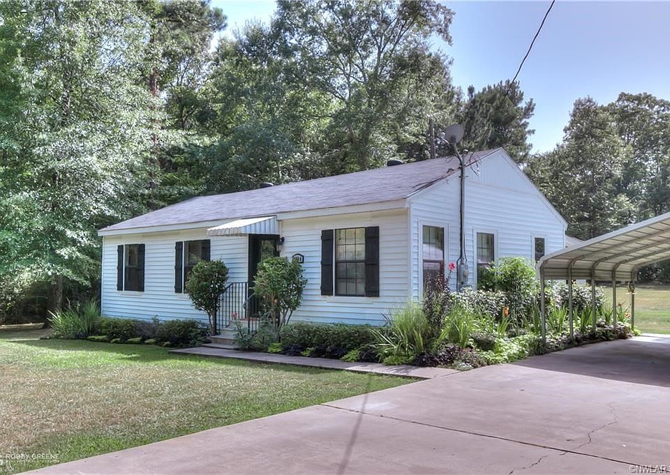 Front view, carport to the right.
