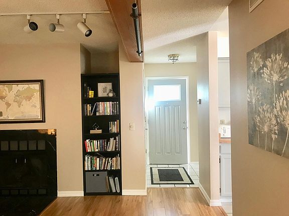 Entry, library, and fireplace.