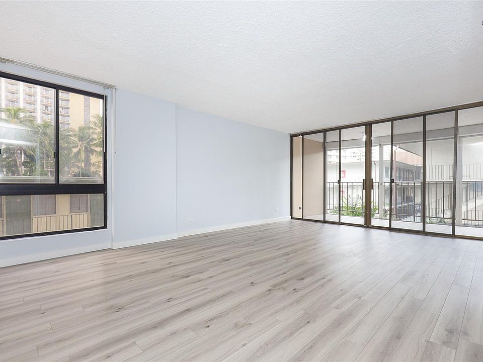 Bright and spacious living area that leads to the covered lanai with retractable privacy panels.