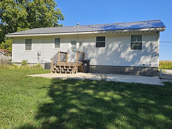 Back of house with a concrete patio