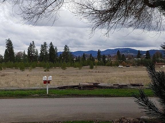 Centennial Trail and river beyond trees.