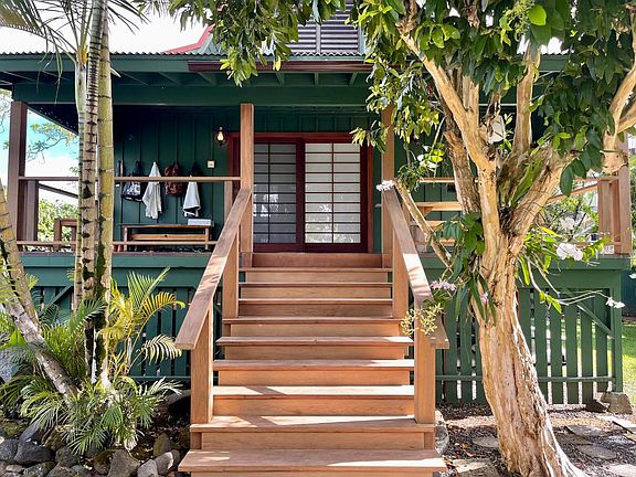 Ipe front staircase with a mature Camphor tree that has several blooming orchids nestled in its lower trunk and branches