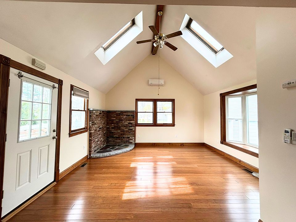 Living/Dining area with access to private back deck, ceiling fan with lights on dimmers, skylights