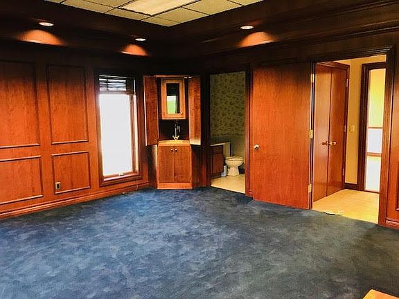 Executive office includes a wet bar and private bathroom.