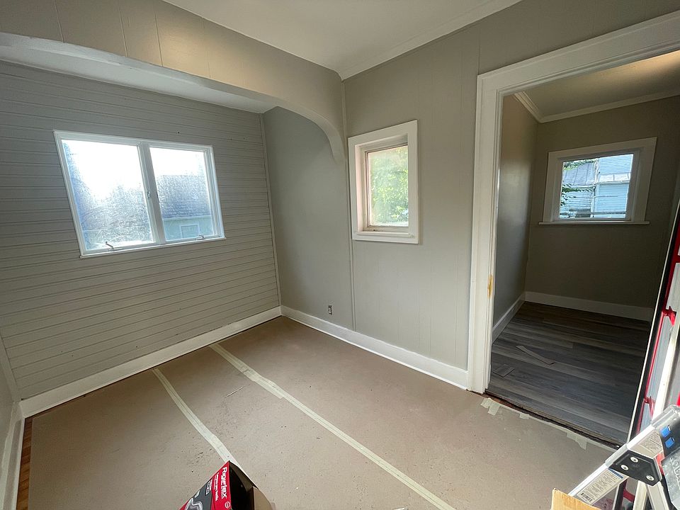 Bedroom with new vinyl plank floors in closet. Bedroom floors are covered to protect hardwood floors