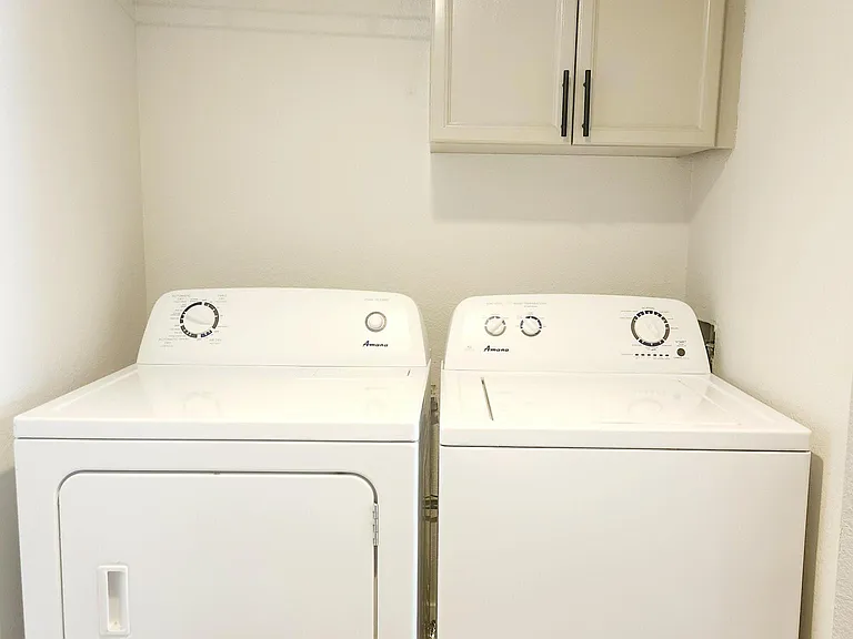 Separate laundry room with washer and dryer.