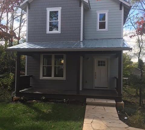 Front of house, standing in off street parking space