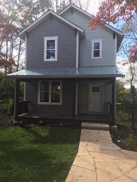 Front of house, standing in off street parking space