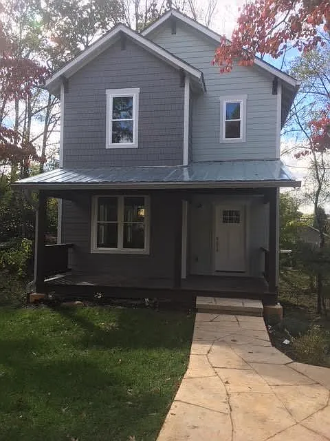 Front of house, standing in off street parking space