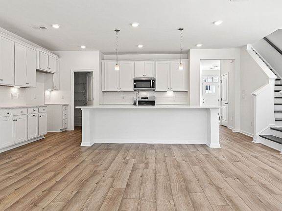 Open kitchen Heron plan by DRB Homes with generous island and tons of cabinet storage