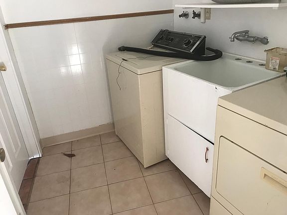 Laundry room with washer dryer through kitchen 