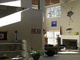 Dramatic two story family room with lots of windows.