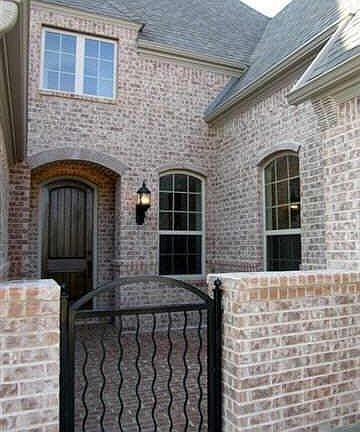 8729 Scarlet Trail ~ Bricked gated courtyard completes the curb appeal of this home!