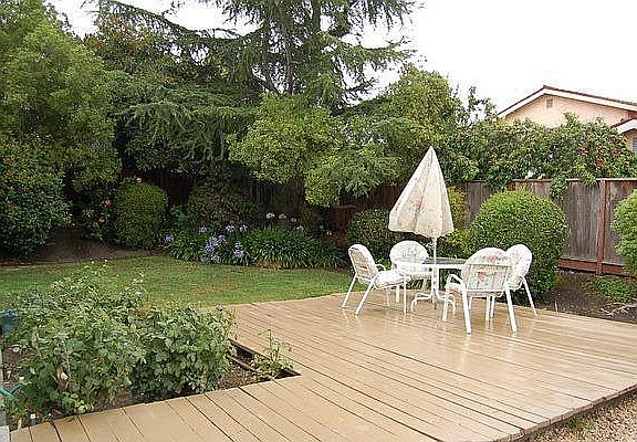Backyard w/deck and mature trees.