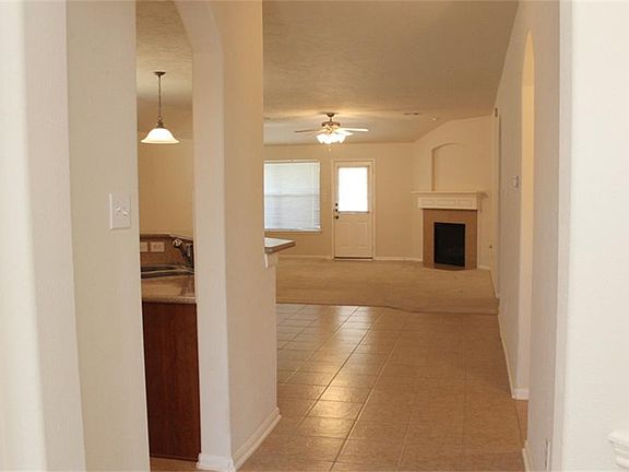 Walk through the door into an open spacious home with tiled floors.
