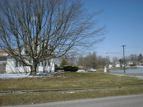 side view featuring sunroom and pond