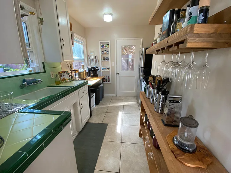 Kitchen looking towards the back door that opens into the private side yard on the west side of the cottage