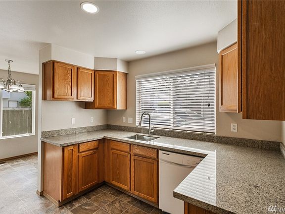 The user-friendly kitchen has been updated with quartz counters and undermount stainless sink. 