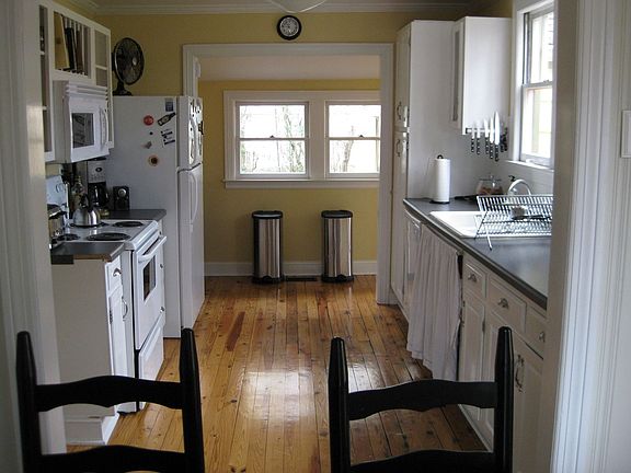View of Kitchen from Dining Area. Original Heart of Pine Floors