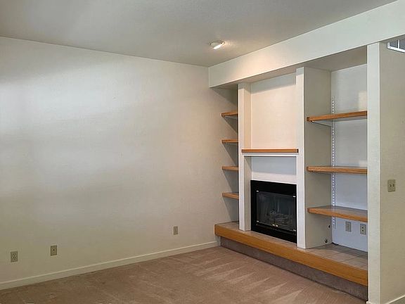 living room, gas fireplace and book shelves main level