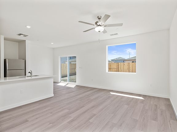The family room is spacious with a ceiling fan.