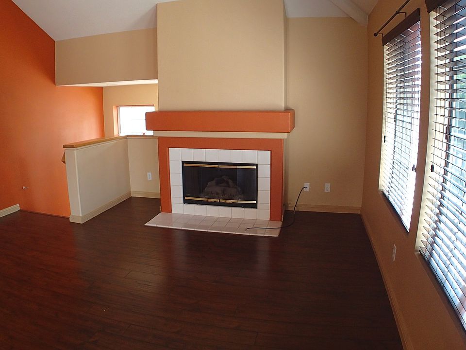 living area with soaring ceilings, fireplace, new blinds thr