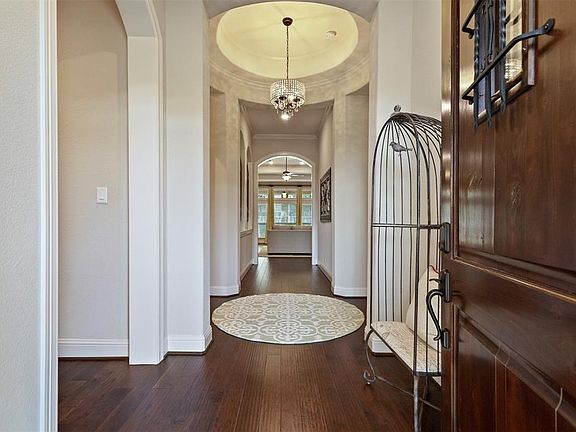 Stunning rotunda foyer leading to spacious secondary bedrooms and bathrooms, custom study, and then on into family room.