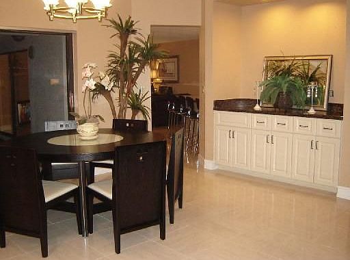 Formal dining room w/ view of pool. Built-in bar w/ granite countertop