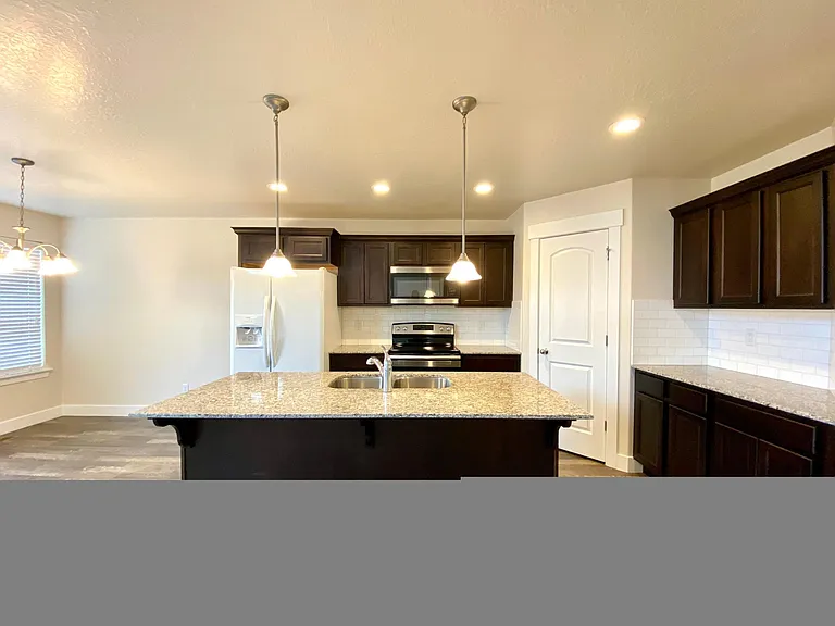Spacious Kitchen with Granite Countertop and Stainless Steel Kitchen Set. Refrigerator included